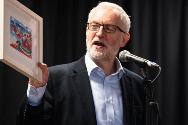 Jeremy Corbyn with a print presented to him by local artist Chas Jacobs.