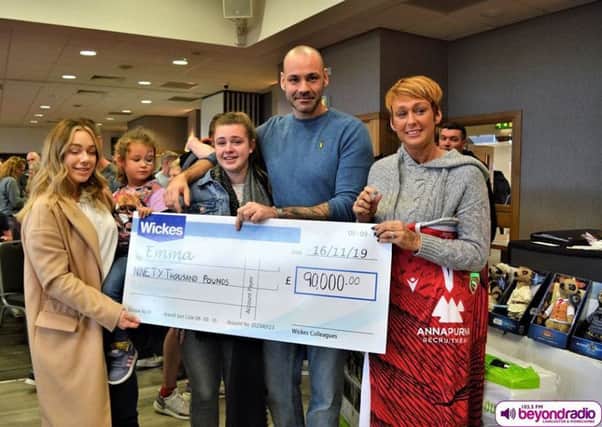 Emma Ellis and family collect their cheque from Wickes staff at the family fun day. Photo credit: Andy Slack, Beyond Radio.