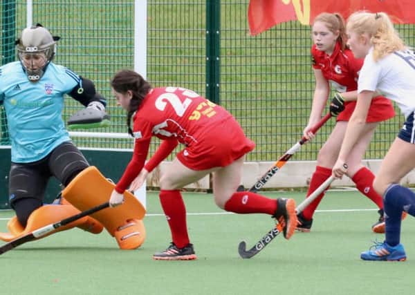 Garstang Hockey Club's Ariana Lowery trying to get round the Fylde keeper with Pip Chapman in support