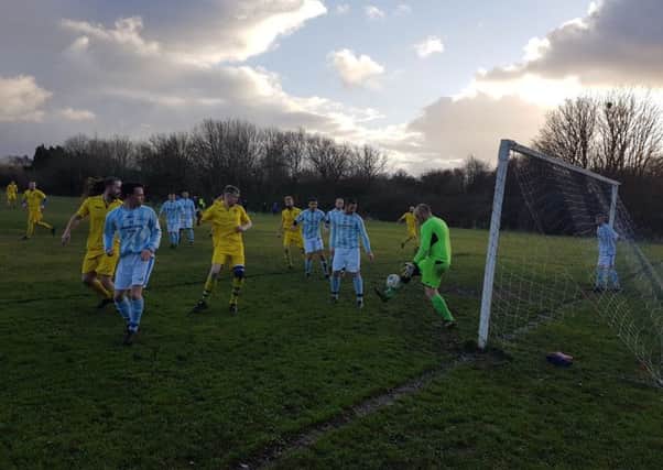 Caton United (yellow) in action against Boys Club. Picture: Michael Ball.
