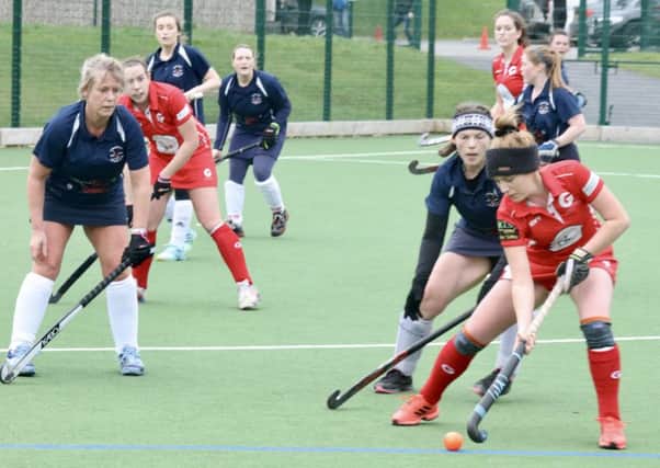 Garstang Hockey Club's Harriet Price on the attack as Steph Roe and Orla McShannon await the ball
