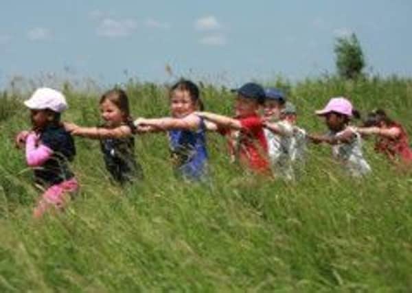 Celebration time, children doing the conga through the reedbed, picture by David McHugh.