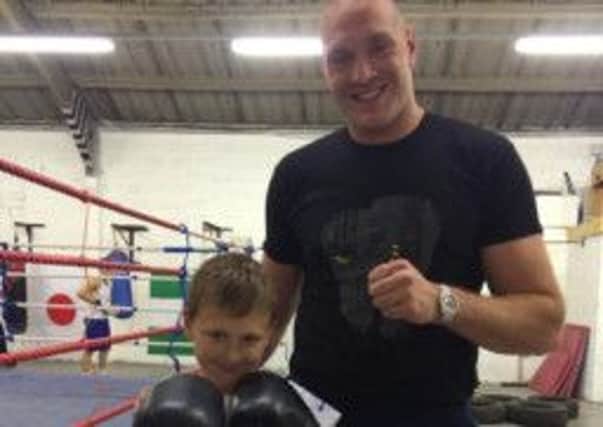 Tyson Fury with a young fighter at Skerton Amateur Boxing Club's new premises.