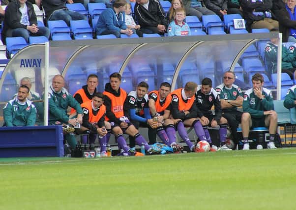 The Morecambe bench looks on against Tranmere.