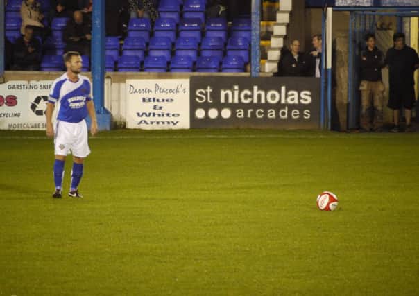Lancaster City's stand-in captain Garry Hunter lines up a free-kick against Padiham.