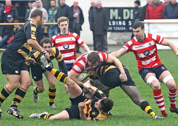 Vale's Michael Barker is brought down by Kendal. Picture: Tony North