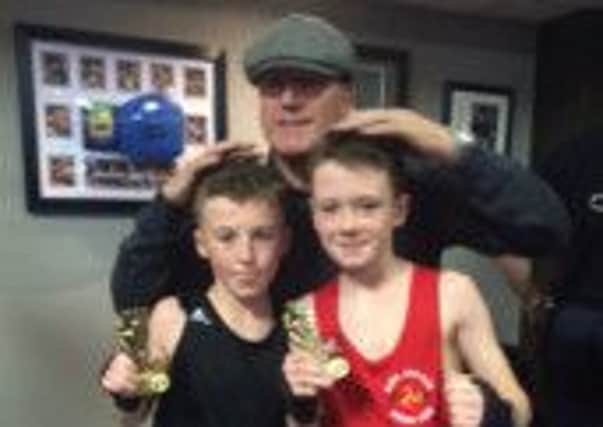 Skerton's Nelson Birchall, in black, with Steve "The Viking" Foster and his opponent from the Isle of Man.