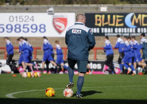 Morecambe manager Jim Bentley looks on during training.