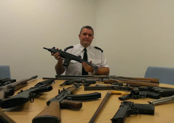 Supt Jon Puttock shows some of the guns seized off Lancashire's streets ahead of a weapon amnesty.