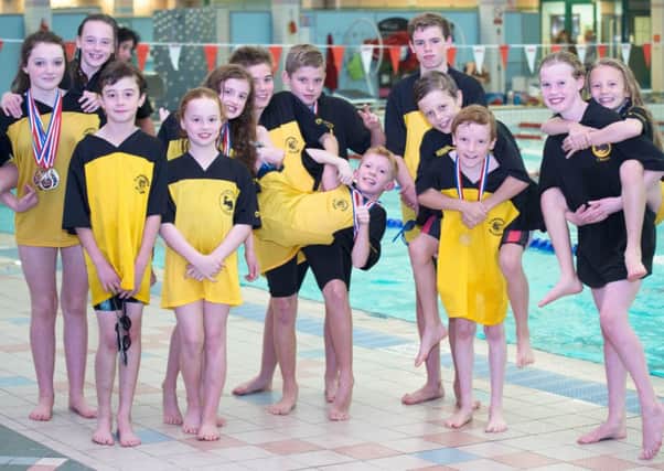 Carnforth Otters swimmers celebrate their success in Blackpool.