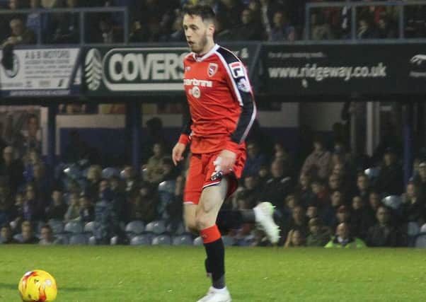 Morecambe's Jamie Devitt on the ball back from injury against Portsmouth.