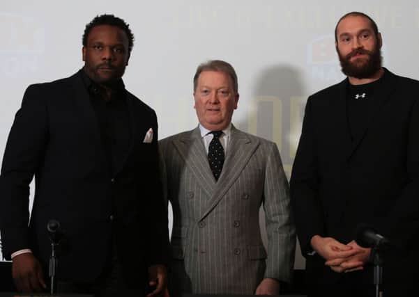 Boxing Promoter Frank Warren with Dereck Chisora (left) and Tyson Fury (right) during the head to head press conference at the Imperial War Museum, London.