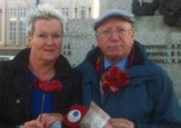 Councillors Margaret Pattison and Ron Sands with their ceramic poppies.
