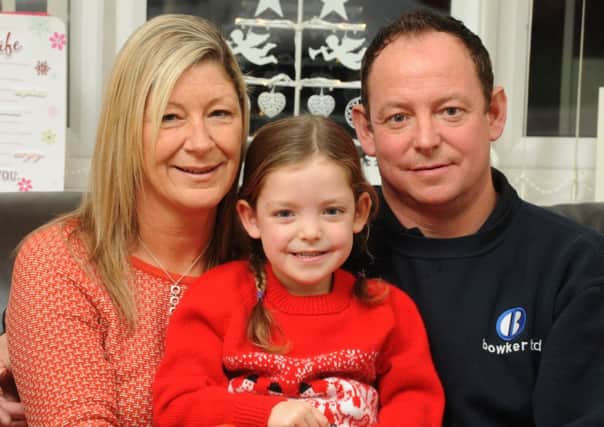 Photo Neil Cross John and Jo Wilson with their daughter Mia, John puts the Christmas lights up every year at Lancaster's St John's Hospice. Jo lost her mum, Chris Furey, at the hospice last year.