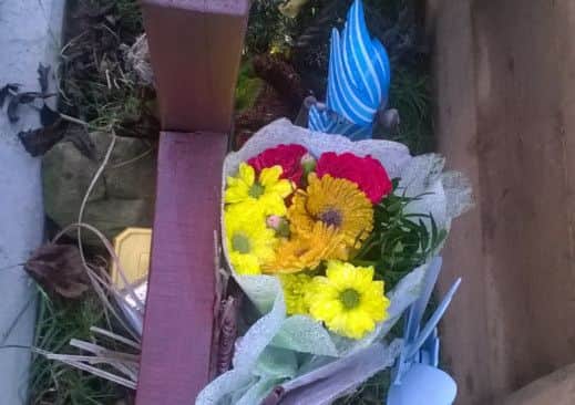 A cross, floral and other tributes left at John Nuttall's grave could not be seen on Christmas Day.