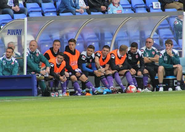 The Morecambe bench looks on at Tranmere earlier in the season.