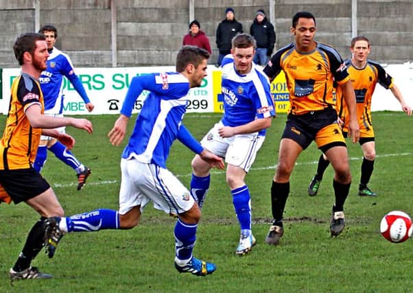 Matty Poole feeds Tom Kilifin as Lancaster City look for an opening against Ossett Albion. Picture: Tony North