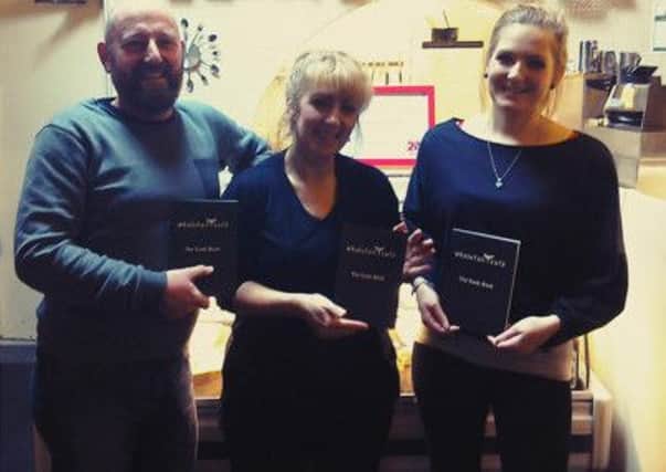 Paulo Bonifacio, Tricia Rawlinson and Jenna Taylor with The Whale Tail Café Cook Book.