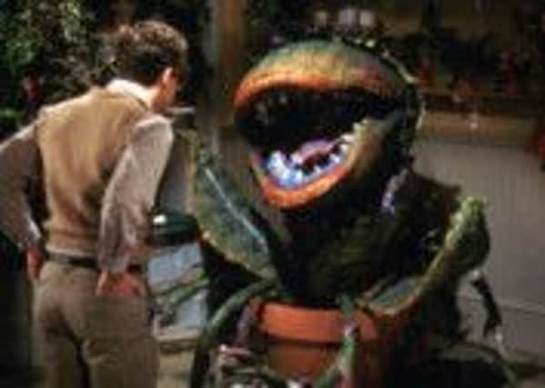 Rick Moranis (Seymour) and the plant in the film adaptation of 'Little Shop of Horrors'.