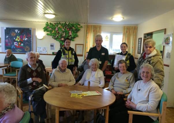 PCSOs Paula Winder and Lucy Hesketh with a number of elderly people at Vale View Day Centre, informing then of the dangers of bogus callers.