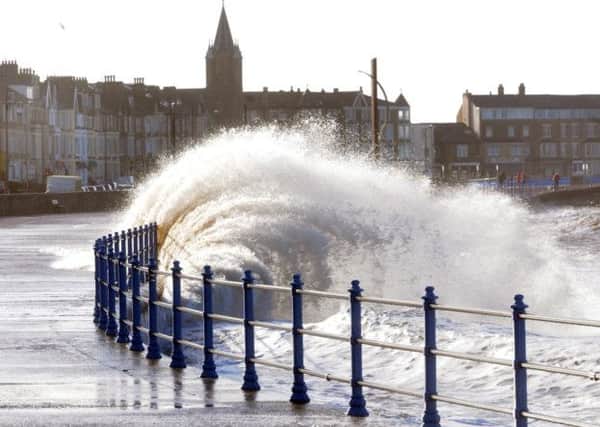 Photo: David Hurst. High tide and stormy weather combined to create high waves on Morecambe Promenade last February