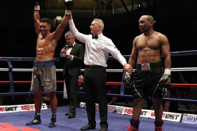 Tomi Tatham has his hand raised in victory. Picture: Paul Simpson