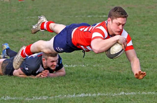 Fergus Owens dives to score for the Vale against Broughton Park.