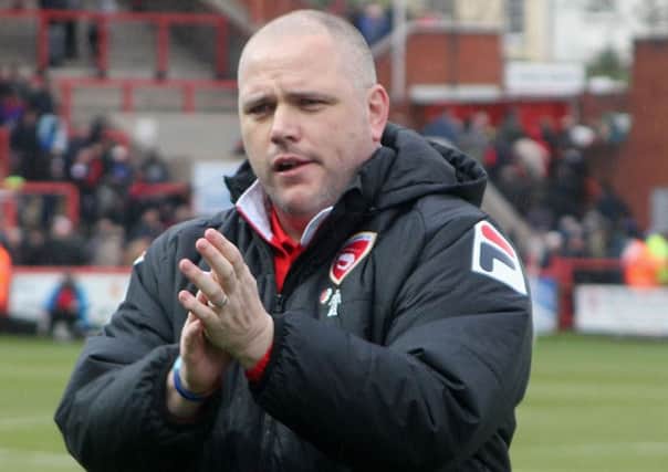 Jim Bentley applauds the travelling Morecambe fans at the end of the Exeter game.