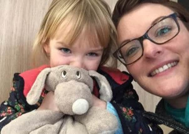 Amelia Adams with her beloved toy Dougal and mum Laura.