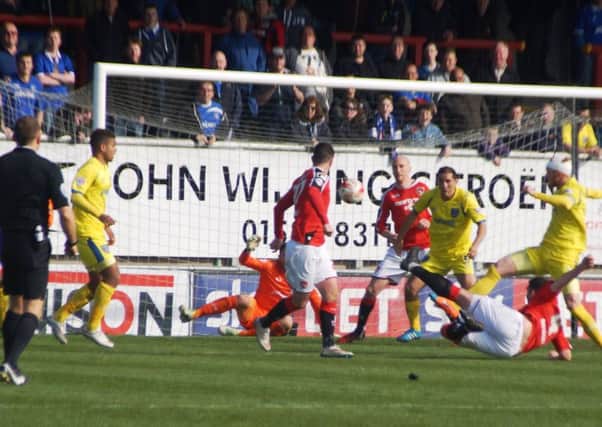 Alex Kenyon scores Morecambe's second goal against Portsmouth.