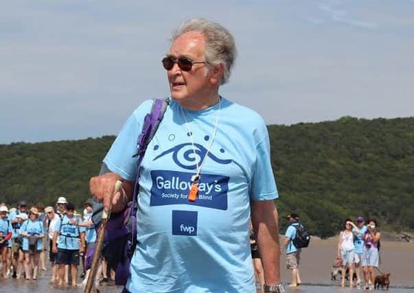 Queens Guide to the Sands, Cedric Robinson MBE, leading the Galoways Society for the Blind Morecambe Bay walk back in 2014.