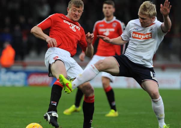 Andy Parrish battles for the ball against Luton earlier in the season.