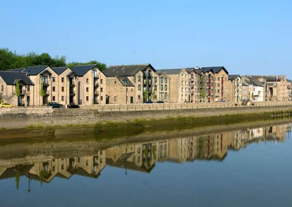 St Georges Quay reflected in the River Lune.
