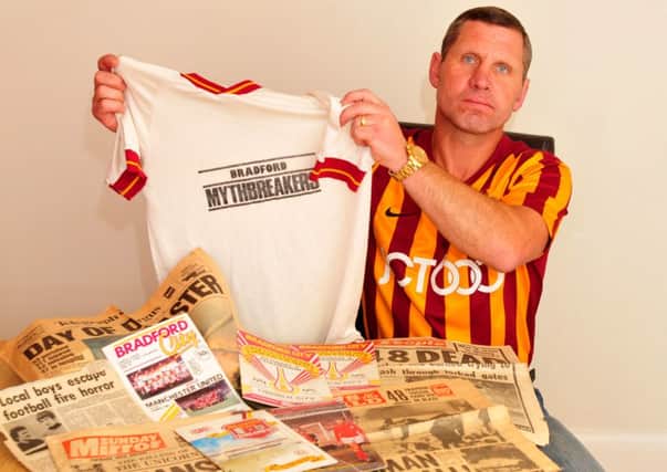 Denby Murgatroyd,who was at the Bradford City FC fire 30 years ago, pictured with cuttings and programmes remembering the fire and the shirt he wore on that day.