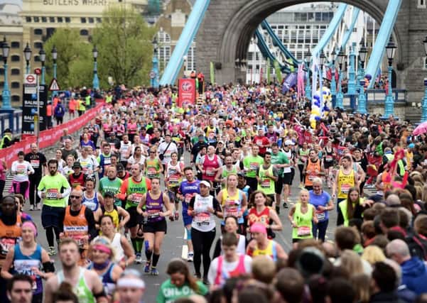 Marathon runners make their way over Tower Bridge during the 2015 Virgin Money London Marathon. Picture: Adam Davy/PA Wire