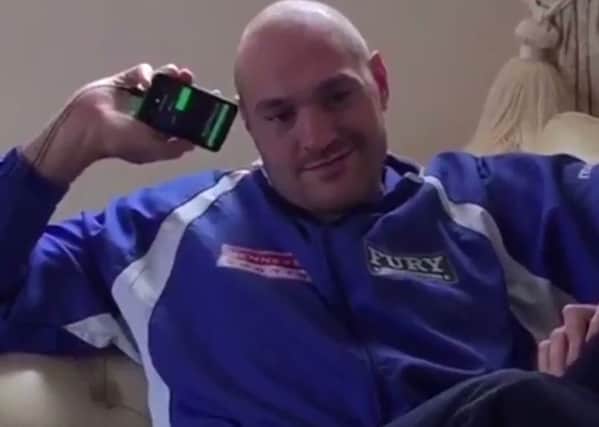 Tyson Fury takes a call from a fan after his number was posted online by his wife Paris.