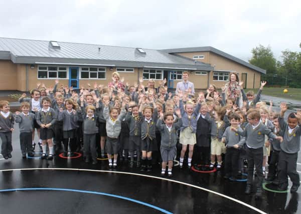 Great Wood Primary School in Morecambe has a new school extension. Pictured are staff and children in the new playground in front of the new extension.