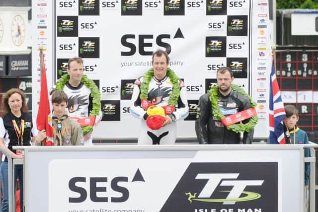 John McGuinness tops the podium after winning his 21st TT, the TT Zero in 2014.