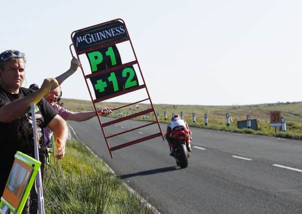 John McGuinness receives his signals during the Senior TT in 2013. Picture: Mark Walters