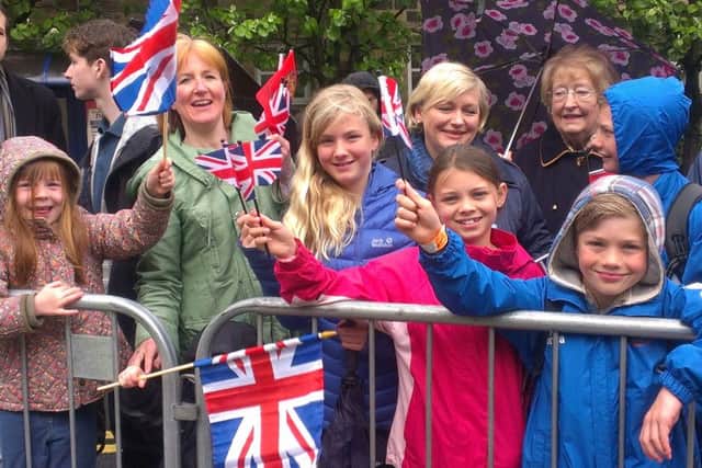 Crowds outside Lancaster Castle wait patiently for the Queen