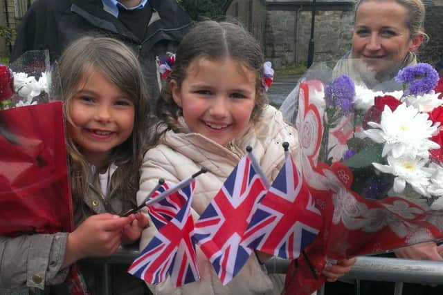 Crowds outside Lancaster Castle wait patiently for the Queen