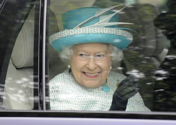 The Queen waves to crowds in Lancaster.