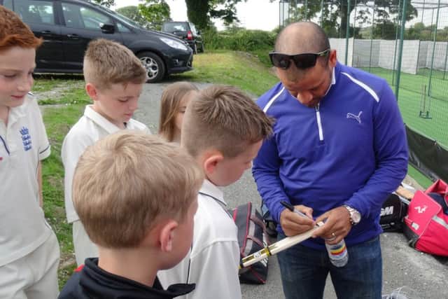 Opening of new Torrisholme CC nets. Ashwell Prince signs a mini bat for under 11s player Koby Cheeseman.
