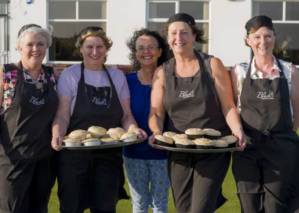 Volunteers Tracey Calderwood, Sandra Bowker, Lady Captain Jan Savage, Lisa John and Kay Murray help to prepare and serve the pies supplied by Blacks Finest Fish & Chips.