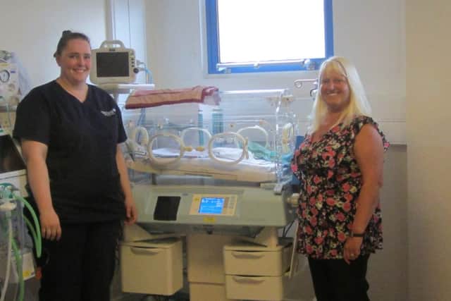 Wendy Hodgson, Paediatrics Ward Manager at the RLI, being presented with the incubator from Alison McMinn