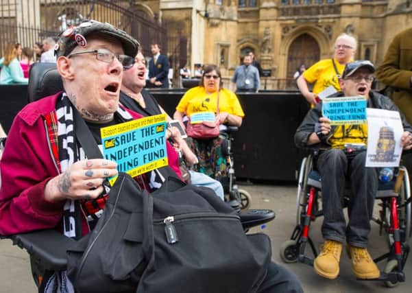 Disability rights campaigners protest outside the Houses of Parliament, in Westminster, London, after they had disrupted a session of Prime Minister's Questions. PRESS ASSOCIATION Photo. Picture date: Wednesday June 24, 2015. The protesters from a group called Disabled People Against Cuts are campaigning against the end of the Independent Living Fund. See PA story PROTEST Parliament. Photo credit should read: Dominic Lipinski/PA Wire