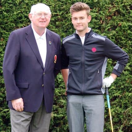 Lancaster Golf Club's Jack Clarkson is congratulated by the President of Lancashire Tony McMunn on playing his first full county fixture against Durham.