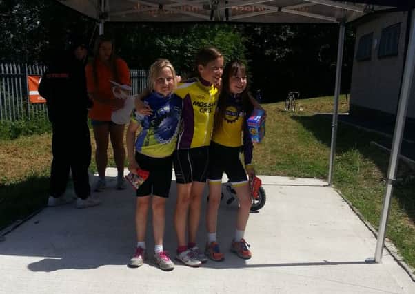Youth D (Under 10) girls Emilia Wood, left, who came second overall and Esther Wong, right, who came third overall, either side of category winner Leah Wilcox of Mossley CRT.