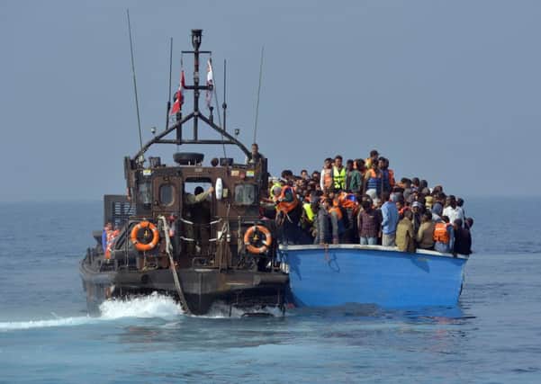 Royal Marines from HMS Bulwark help rescue migrants stranded on a boat, thirty miles off the Libyan coast. Photo: Rowan Griffiths/Daily Mirror/PA Wire