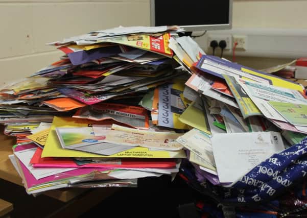 Piles of mail collected from the home of a 93-year-old woman who was targeted by bogus and scam mail